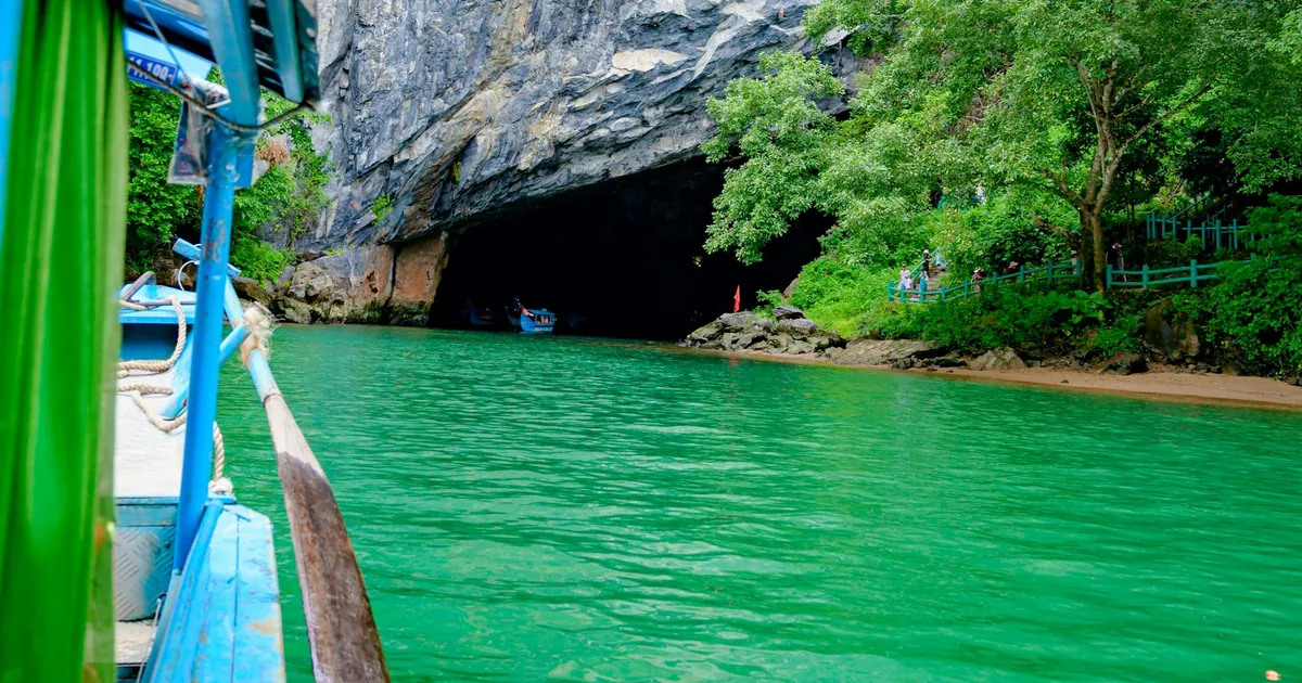 Boat entering Phong Nha Cave on the emerald Son River, Quang Binh, Vietnam